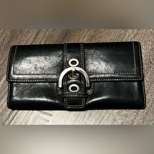 Coach black leather wallet w/ coin pocket, 10 card holders & 4 bill sections.